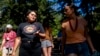 FILE - Serina Fast Horse of the Sicangu Lakota and Blackfeet Tribes, left, talks with Jacy Bowles, of Xicana and Diné descent, as they walk during the 2023 Tribal Climate Camp on the Olympic Peninsula near Port Angeles, Washington, Aug. 16, 2023.