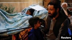 Sara, a 25-year-old Afghan woman from the quake-hit district of Zindajan receives treatment at a hospital compound in Herat, Afghanistan, Oct. 11, 2023. She was wounded during the earthquake.