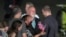 Reporter Evan Gershkovich is greeted by his parents and other family members on the tarmac at Andrews Air Force Base, Md., following his release as part of a 24-person prisoner swap between Russia and the United States, Aug. 1, 2024. 
