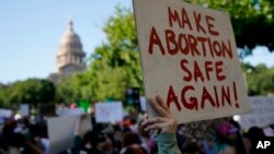 Transparent "Učinite abortus potpuno bezbednim" na protestu protiv ukidanja prava na abortus u Ostinu, Teksasu, jun 2022. (AP/Eric Gay)
