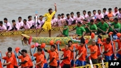 Participants row dragon boats during a competition as part of the Water Festival on the Tonle Sap river in Phnom Penh on November 26, 2023.
