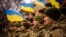 FILE - Ukrainian soldiers celebrate a Day of Unity in Odesa, Ukraine, Feb. 16, 2022. A Ukrainian court recently found blogger Wang Jixian, a software engineer from Beijing who lives in Odesa, guilty of posting videos that could harm national security.