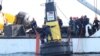Philippine Coast Guard members place a buoy in a part of the South China Sea over which Manila claims sovereignty, in this handout image obtained May 15, 2023. (Philippine Coast Guard via Reuters). Staking its own claims, China has since responded in kind.