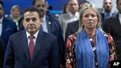 Iraqi National Security Advisor Qassim al-Araji, left, and U.N. special representative to Iraq Jeanine Hennis-Plasschaert, attend a conference about Al-Hol camp in Syria which hosts families of IS members, in Baghdad, Iraq, Monday, June 12, 2023. 