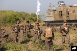 FILE - U.S. Marines take part in an amphibious landing operation at the Super Garuda Shield multinational military exercise in Situbondo, East Java, Indonesia, Sept. 10, 2023.