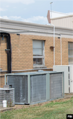 The FBI says Thomas Crooks used the tan machine to the right to crawl onto the roof of the building from which he tried to assassinate former U.S. President Donald Trump in Butler, Pennsylvania, on July 13, 2024.