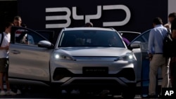 File - Visitors examine BYD ATTO 3 in Munich, Germany, Sept. 8, 2023. China's car industry groups say the country is set to surpass Japan to become the world's top car exporter for 2023, driven by the Russian market and a growing global appetite for electric vehicles.
