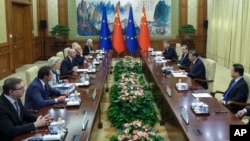 FILE - Chinese President Xi Jinping, second right, talks to European Commission President Ursula von der Leyen, third left, in Beijing, Dec. 7, 2023. Draft EU regulations announced Jan. 24, 2024, appear likely to hit Chinese exports when approved.