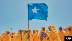 FILE - Students wave a Somali flag during a demonstration in support of Somalia's government following the port deal signed between Ethiopia and the breakaway region of Somaliland at Eng Yariisow Stadium in Mogadishu on Jan. 3, 2024.