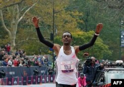 Ethiopia's Tamirat Tola celebrates winning the 52nd Edition of the New York City Marathon, Nov. 5, 2023.