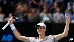 Jannik Sinner of Italy celebrates after defeating Novak Djokovic of Serbia in their semifinal at the Australian Open tennis championships at Melbourne Park, Melbourne, Australia, Jan. 26, 2024. 