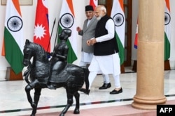 PM India Narendra Modi (kanan) dan PM Nepal Pushpa Kamal Dahal menjelang pertemuan mereka di Rumah Hyderabad, New Delhi, 1 Juni 2023. (Sajjad HUSSAIN / AFP)