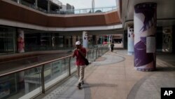 FILE - A man plays a harmonica while walking by a deserted Evergrande city plaza in Beijing, Sept. 18, 2023. China's languishing economy could encourage Beijing to become more cooperative with the U.S. on North Korea, one expert thinks.