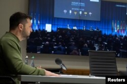Ukrainian President Volodymyr Zelenskyy speaks via video link during the NATO Parliamentary Assembly in Copenhagen, amid Russia's attack on Ukraine, in Kyiv, Ukraine, Oct. 9, 2023. (Ukrainian Presidential Press Service/Handout via Reuters)