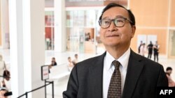 FILE - Cambodian opponent in exile and leader of the Cambodia National Rescue Party (CNRP) Sam Rainsy, speaks to the press as he arrives at the court house accused in a defamation lawsuit filed by Cambodia's prime minister, in Paris on September 1, 2022.
