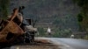 FILE — A man crosses the road near a destroyed truck in the Tigray region of northern Ethiopia, May 11, 2021. Among the many challenges for journalists covering conflict in Ethiopia is an increased risk of arrest, according to data by a media watchdog.