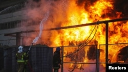 Firefighters work to put out a fire in a thermal power plant, damaged by a Russian missile strike in Kyiv, Ukraine, Oct. 18, 2022. (State Emergency Service of Ukraine/Handout via Reuters)