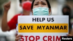 FILE - Myanmar citizens protest against the military coup in front of the U.N. office in Bangkok, Thailand, Feb. 17, 2021.