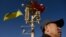 FILE - A man passes under a lamp post displaying Ukrainian and Chinese flags on Tiananmen Square in Beijing, China, Dec. 5, 2013. While Ukrainian President Volodymyr Zelenskyy has said that China has shown “neutrality” in his country's conflict with Russia, others beg to differ.