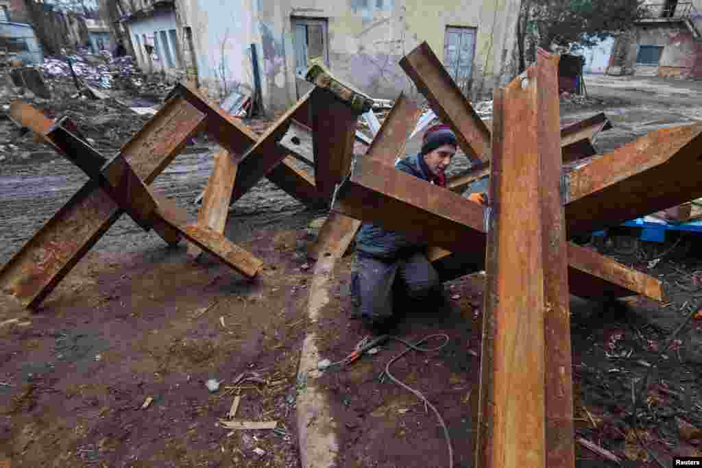 A local resident makes anti-tank obstacles to defend his and others cities, as Russia&#39;s invasion of Ukraine continues, in Lviv, Ukraine, March 2, 2022. 