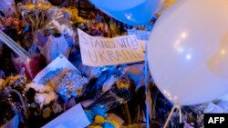 Flowers, signs, and balloons sit on the steps of the Ukrainian Embassy in Washington, on Feb. 26, 2022.