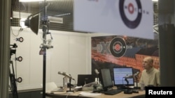 FILE - An anchor of Russian radio station Ekho Moskvy works at the station's office in Moscow, Oct. 23, 2017. 