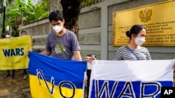 Para pengunjuk rasa memegang spanduk mengecam invasi Rusia ke Ukraina di depan Kedutaan Besar Rusia di Jakarta, 4 Maret 2022. (Foto: AFP)