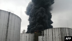 This handout picture released by the State Emergency Service of Ukraine, shows smoke rising from an oil depot, which is said was hit by shelling, in Chernihiv on March 3, 2022. 