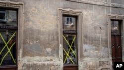 A woman has breakfast inside a cafe in Lviv's downtown, western Ukraine, March 4, 2022.