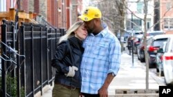 Maria and her fiancé, David, pose for a photograph near their Chicago home on March 4, 2022. 