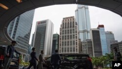 FILE - Participants are seen departing the venue for the Global Financial Leaders' Investment Summit in Hong Kong, Nov. 2, 2022.