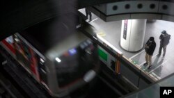 Passengers wait at platform for their trains arrival at Tokyu Railways' Shibuya Station, April 20, 2022, in Tokyo, Japan.