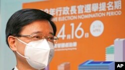 Former Hong Kong Chief Secretary John Lee poses for a photograph before submitting his candidacy for the Election of the Chief Executive, in Hong Kong, April 13, 2022. 