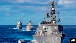 In this photo from the Defense Visual Information Distribution Service, a ship from Japan's Maritime Self-Defense Force sails during MALABAR 2021 on Aug. 27, 2021. The U.S., India and Australia also participated in the exercise, held in the Philippine Sea and Bay of Bengal.