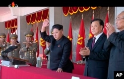 FILE - In a video image, North Korean leader Kim Jong Un, center, and Liu Yunshan, China's Communist Party's No. 5 leader, second right, waves during a ceremony to mark the 70th anniversary of the country's ruling party, in Pyongyang, Oct. 10, 2015.