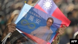A supporter of the main opposition Kuomintang (KMT) and candidate Chiang Wan-an (not pictured) attends a mayoral election campaign rally in Taipei on Nov. 26, 2022.