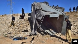 FILE - Pakistani security officials inspect a damaged truck at the site of suicide bombing on the outskirts of Quetta, Pakistan, Nov. 30, 2022. The outlawed Tehrik-e-Taliban Pakistan, also known as the Pakistani Taliban, claimed responsibility for the attack.