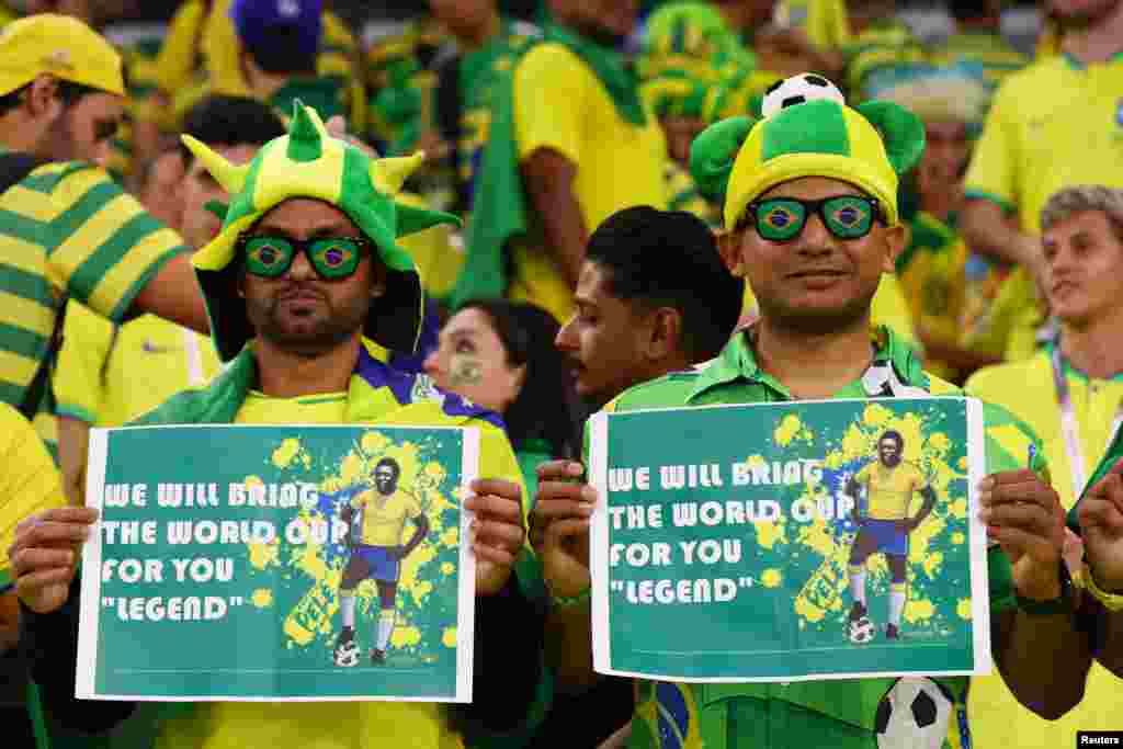 Brazil fans hold signs commemorating former player Pele inside the stadium in Qatar at the 2022 FIFA World Cup, December 9, 2022