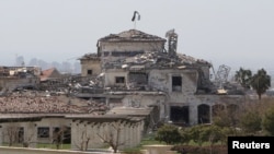 View of a damaged building in the aftermath of missile attacks in Erbil, Iraq, March 13, 2022. 