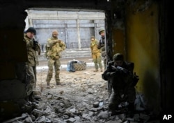 FILE - Belarusian volunteers receive military training at the Belarusian Company base in Kyiv, Ukraine, Tuesday, March 8, 2022.
