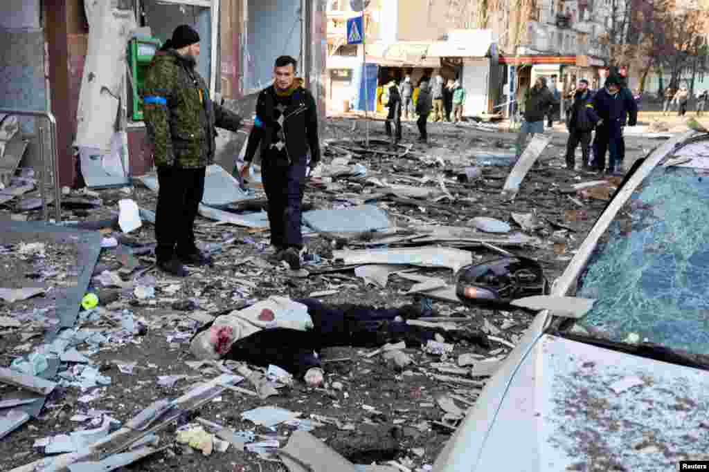 A body of a person is seen on ground near a building destroyed by Russian shelling in Kyiv,&nbsp; March 14, 2022.