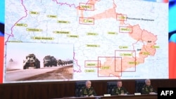 Russian officials hold a briefing on Russian military action in Ukraine, in Moscow on March 25, 2022. The screen shows the map of Ukraine.