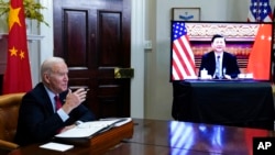 FILE - President Joe Biden meets virtually with Chinese President Xi Jinping from the Roosevelt Room of the White House in Washington, Nov. 15, 2021. 