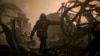 A Ukrainian firefighter walks inside a large food products storage facility which was destroyed by an airstrike in the early morning hours on the outskirts of Kyiv, Ukraine, March 13, 2022. 
