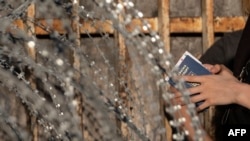 Asylum-seekers from Ukraine wait for US border authorities to allow them in on the Mexican side of the San Ysidro Crossing port in Tijuana, Baja California state, Mexico, on March 24, 2022.