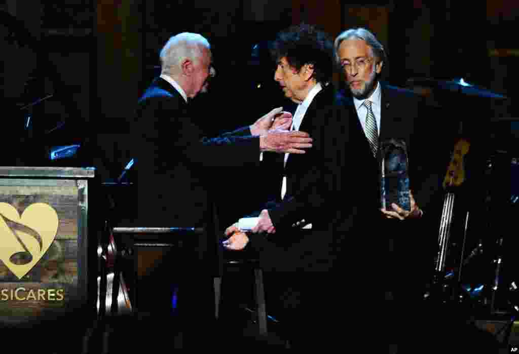President Jimmy Carter, left, presents Bob Dylan with the award for 2015 MusiCares Person of the Year at the Los Angeles Convention Center in Los Angeles, Feb. 6, 2015.