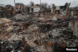 Destroyed houses are seen on the front line near Kyiv as Russia's invasion of Ukraine continues, Ukraine, March 30, 2022.