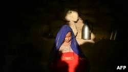 A little girl betrothed to a 23-year-old man to whose family was indebted, sits inside a tent at the Shamal Darya Internally Displaced People camp in Qala-i-Naw, Badghis Province, Oct. 14, 2021.
