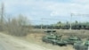 A still image from video shows tanks and military vehicles in Maslovka, Voronezh Region, Russia April 6, 2021. 