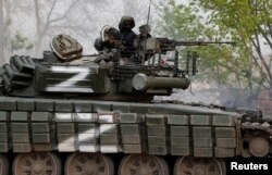 A service member of pro-Russian troops is seen atop a tank during fighting in Ukraine-Russia conflict near the Azovstal steel plant in the southern port city of Mariupol, Ukraine May 5, 2022.